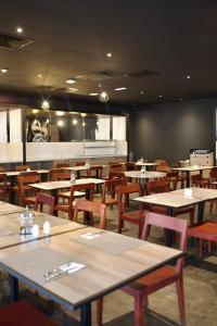 a dining room with tables and chairs and a chalkboard at ONOMO Hotel Tanger Med in Tangier +37 photos
