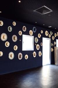 a room with a wall with a bunch of hats on it at ONOMO Hotel Tanger Med in Tangier