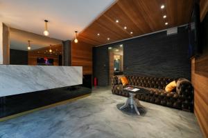 a living room with a couch and a large tv at Ataşehir Kurucesme Palace in Istanbul