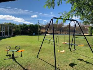 an empty playground with a swing set in a park at Casa Monte da Eira in Giões