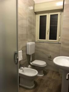 a bathroom with a toilet and a sink at Casa Narciso - Mondello in Mondello
