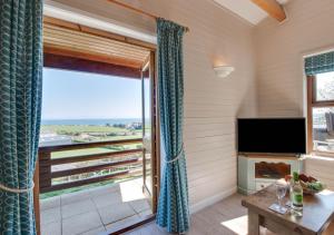 a living room with a view of the ocean at Gorwel in Abersoch