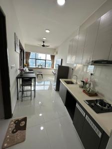 a kitchen with a counter and a table in it at Beach Apartment @ Country Garden Danga Bay in Johor Bahru