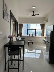 a living room with a table and a kitchen at Beach Apartment @ Country Garden Danga Bay in Johor Bahru