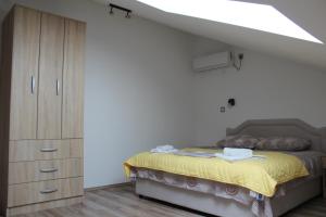 a bedroom with a bed and a dresser in a room at Panorama view apartment VANJA in Baošići