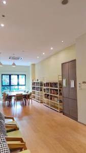 a library with a table and chairs and bookshelves at Beach Apartment @ Country Garden Danga Bay in Johor Bahru
