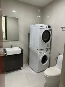 a bathroom with a washing machine and a sink at Beach Apartment @ Country Garden Danga Bay in Johor Bahru