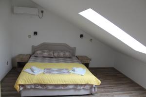 a bedroom with a bed with a yellow bedspread at Panorama view apartment VANJA in Baošići