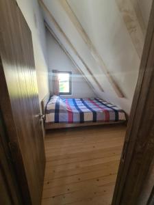 a bedroom with a bed in a attic at Kira Apartments Mavrovo in Mavrovo