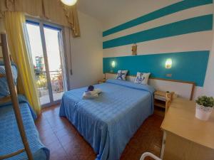 a small child laying on a bed in a bedroom at PetlyApartments in Bellaria-Igea Marina +51 photos