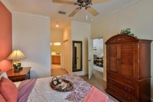 a bedroom with a bed with a wooden dresser and a dresser at Hammock Beach 2BD 2BR Villa! Walk to the Ocean! in Palm Coast