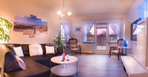 ein Wohnzimmer mit einem Sofa und einem Tisch in der Unterkunft Ferienwohnung Gooß in Cuxhaven