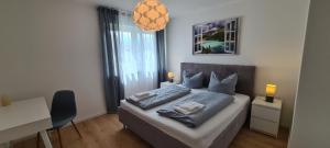 a bedroom with a bed with two pillows on it at Panorama Apartments in Füssen