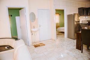 a kitchen with a sink and a refrigerator at Happy Holidays Style Residences in Paramaribo +33 photos