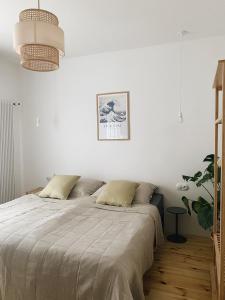 a bedroom with white walls and a large bed at powiew in Świnoujście