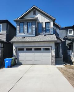 a house with a garage and a driveway at Luxury suite in Calgary NW in Calgary