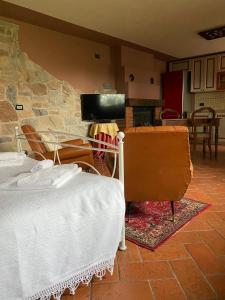a bedroom with a bed and a stone wall at Antica Casa Fenaroli in Iseo