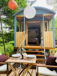a tiny house on a deck with a gazebo at Domaine de Bourbacoup in Tulle