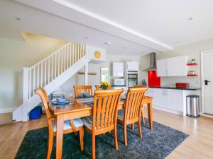 a kitchen and dining room with a table and chairs at The Barn at Courtleigh in Kingsbridge