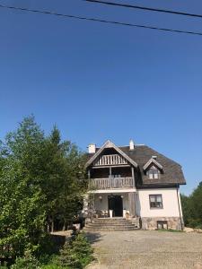 a large white house with a roof at Wiejski Zakątek nad Wigrami in Rosochaty Róg