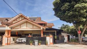 a house with a car parked in front of it at Pool Villa Max Bath Tub BBQ Steamboat Party 5Bedroom 23Pax Full Airconditioned in Melaka