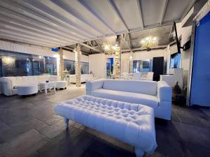 una sala de estar con sofás y mesas blancos. en Cape Serenity Mansion en Ayia Napa