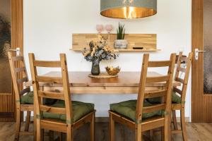 a dining room table with chairs and a vase with flowers at Ferienapartment Marktblick in Oberstdorf