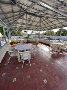 a patio with tables and chairs on a roof at Hostal 53 Boutique Santo Domingo in Santo Domingo