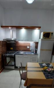 a small kitchen with a stove and a table in it at Cabañas Montoya in Paraná