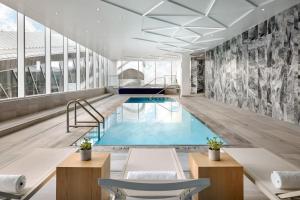 a swimming pool in a building with a mural at JW Marriott Edmonton ICE District in Edmonton