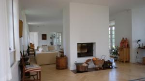 a living room with a white couch and a tv at DENMARK SEA FRONT ENCHANTING - Beach Villa in Solrød Strand