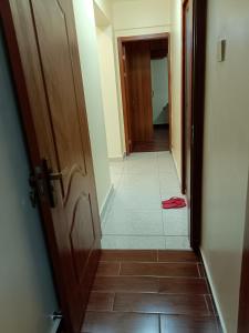 a hallway with a door and a tile floor at Luxurious 2bedroom furnished apartment in Nairobi