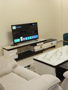 a living room with a flat screen tv on a table at Luxurious 2bedroom furnished apartment in Nairobi