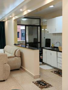a living room with a couch and a kitchen at Luxurious 2bedroom furnished apartment in Nairobi