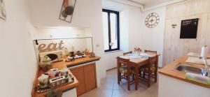 A kitchen or kitchenette at DIMORA IL CAMALEONTE apartments in nature with pool