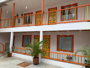 a building with colorful doors and windows at El Rincón de Granada Hotel in Cali