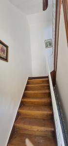 a staircase with wooden floors and a white wall at S.Soares Yellow Beato in Lisbon