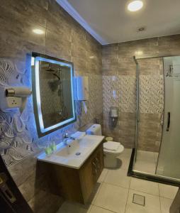 a bathroom with a sink and a shower and a toilet at Fragrant Rose in Wadi Musa