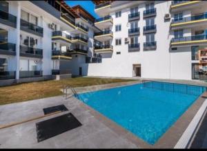 a large swimming pool in front of a building at ATLAS APART/DEMRE in Demre