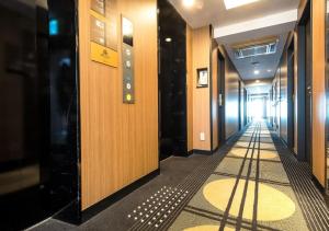 a hallway of a building with a long corridor at APA Hotel Namba-Shinsaibashi in Osaka