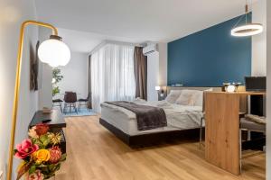 a bedroom with a bed and a blue wall at One88 Apartments in Bucharest