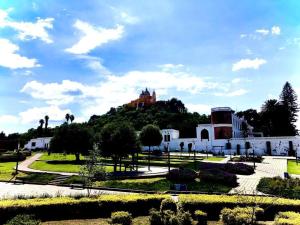 a building with a castle on top of a hill at Corazon de San Pedro Cholula in Cholula