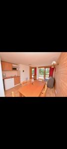 a living room with a wooden table and chairs at Appartement 6 couchages avec terrasse in Chamrousse
