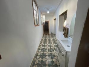 a bathroom with a tile floor and a sink at Au cœur du Médina in Fez