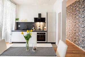 eine Küche mit einem Tisch mit gelben Blumen in einer Vase in der Unterkunft Casa Borghese - Your perfect stay in Rome in Rom