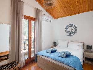 a bedroom with a bed and a large window at Villa Aura Pine in Agia Pelagia +38 photos