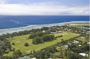 an aerial view of a park next to the ocean at Absolute Beachfront - A Slice of Paradise! in Rarotonga