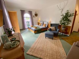 ein Wohnzimmer mit einem Bett und einem Sofa sowie ein Zimmer in der Unterkunft Vanilla Hof in Naumburg
