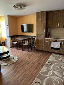 a kitchen and dining room with a table and chairs at Apart 47 in Smolyan