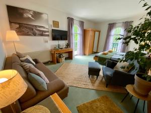 a living room with a couch and a bed at Vanilla Hof in Naumburg